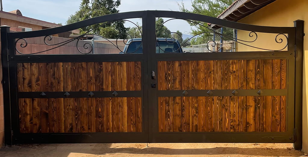 Custom commercial iron and wood gate fabricated for secure property entrance