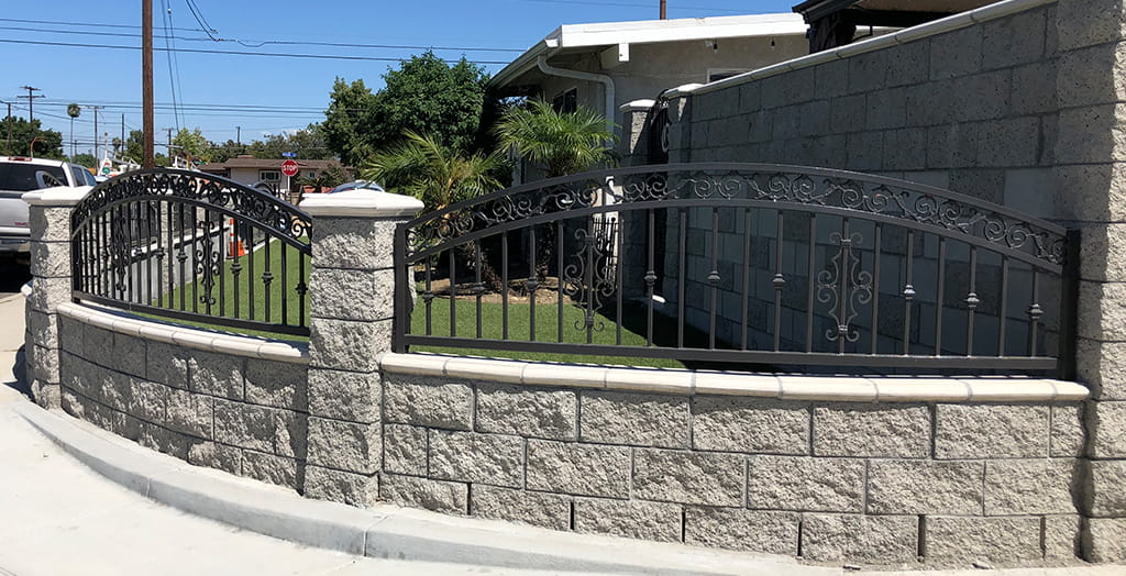 Commercial iron fence and railing fabrication integrated with masonry for perimeter security